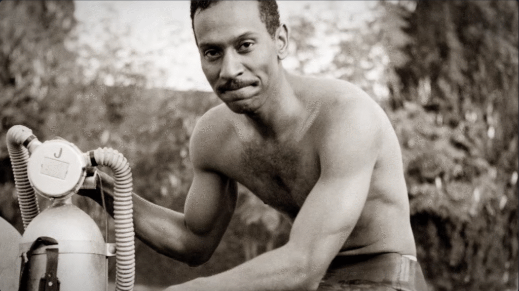 Black‑and‑white portrait of a Black man with scuba gear